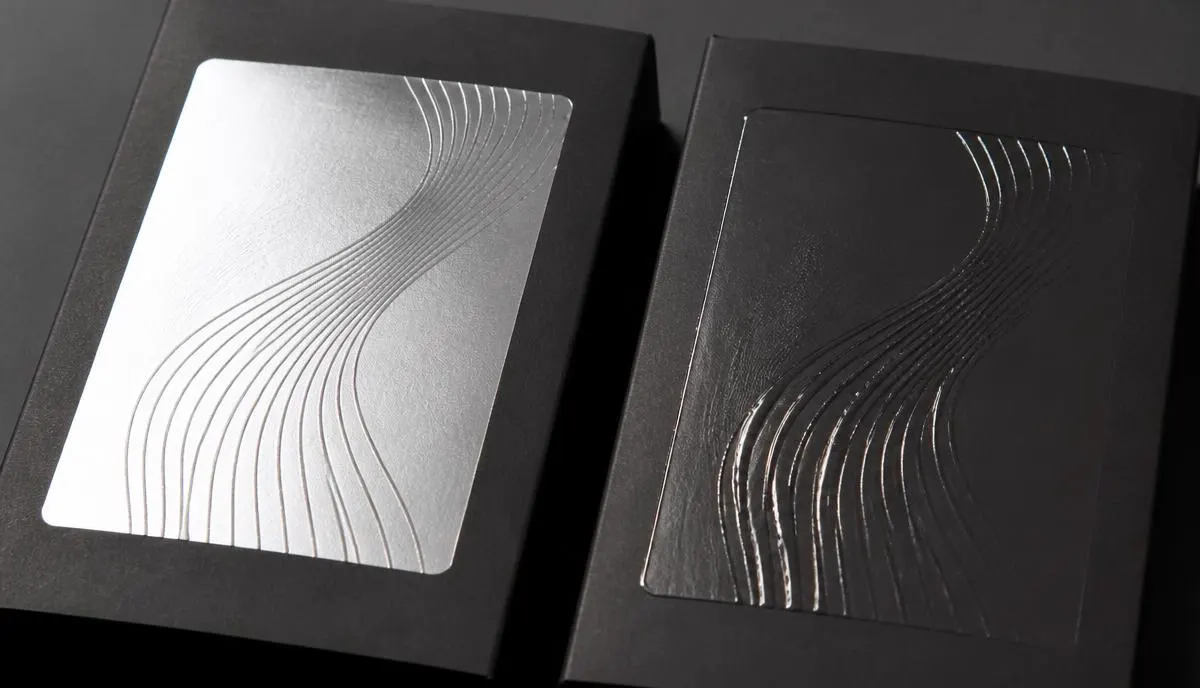 Flat cold foil finish compared with raised digital foil embellishment on printed packaging