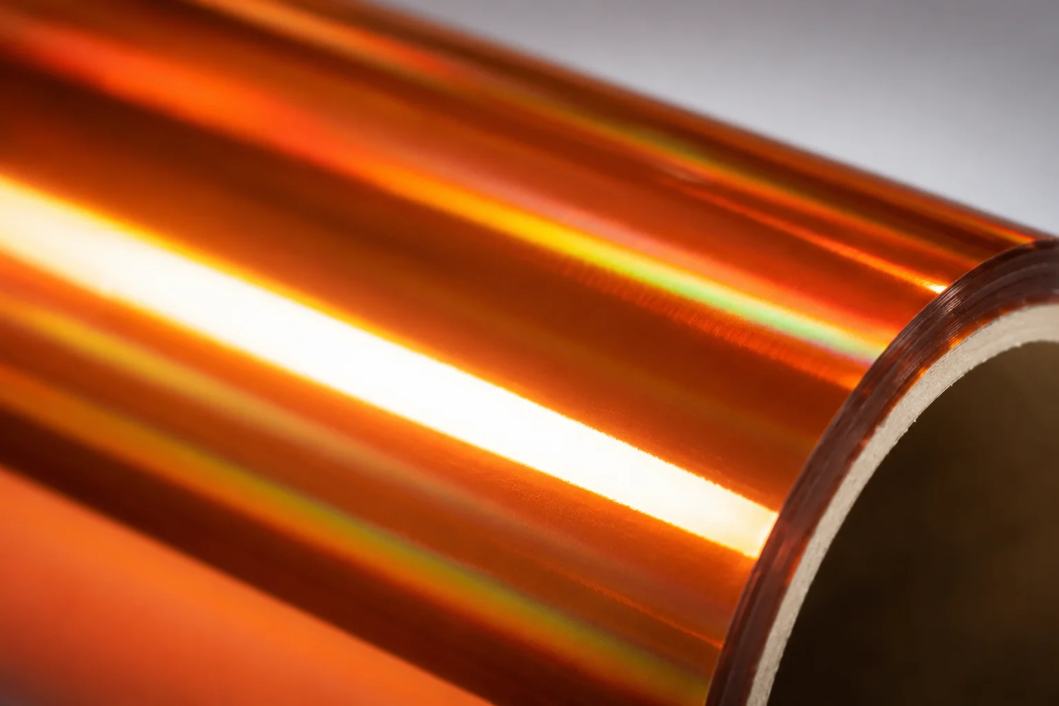 Macro detail of Copper cold foil surface showing 86 GU mirror gloss with rich hand-hammered warm chroma