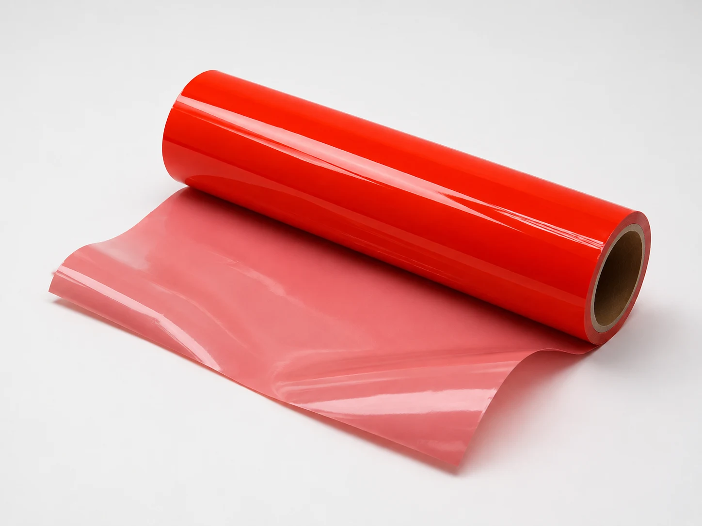 Fluorescent cold foil web unwinding with translucent leader sheet showing consistent neon coverage