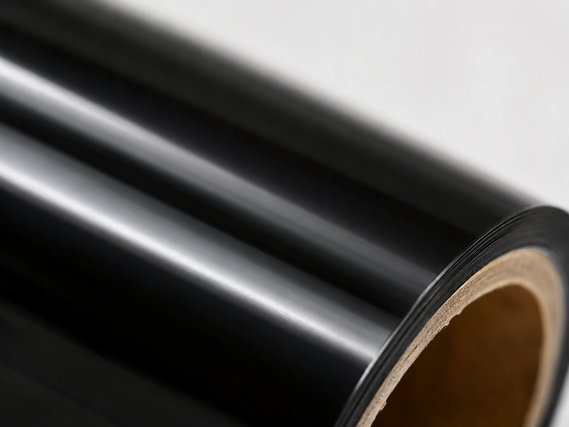 Macro detail of Matte Black cold foil surface showing velvet, anti-glare finish with deep tonal black